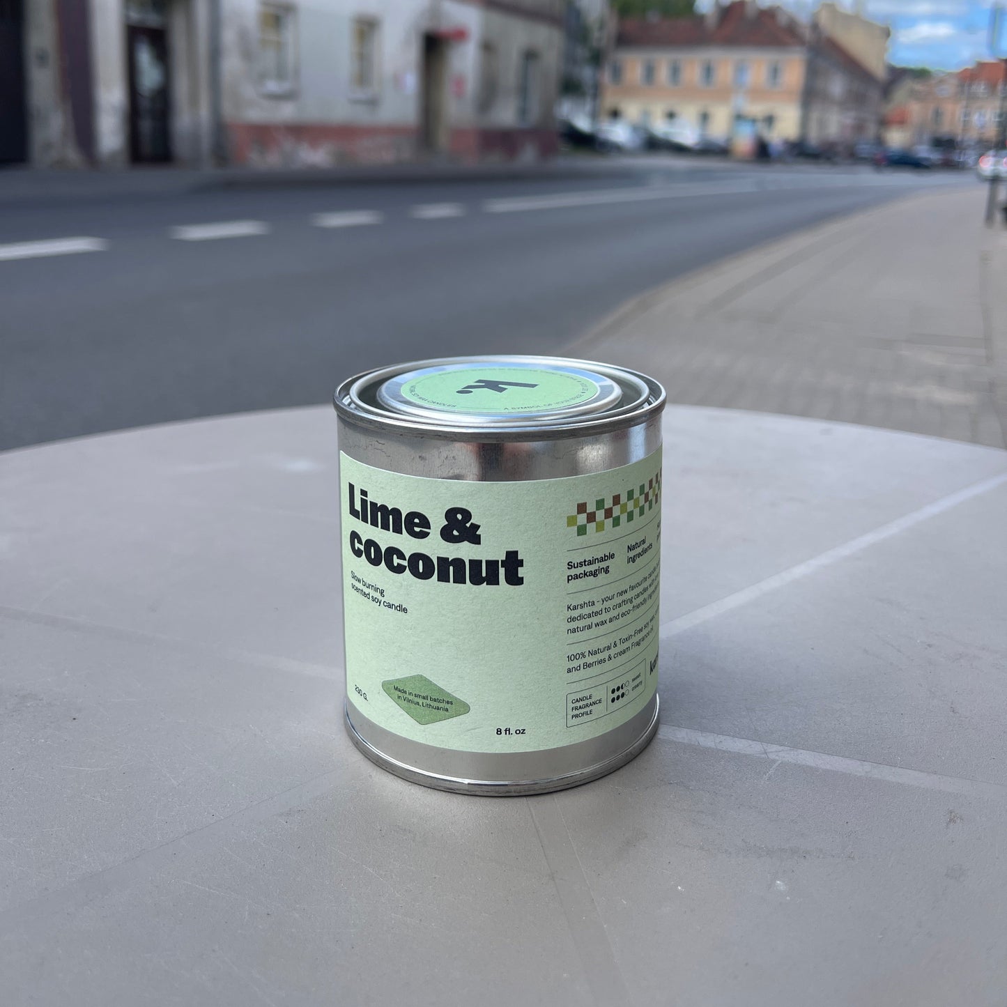 Can of 'Lime & Coconut' on a street with buildings in the background