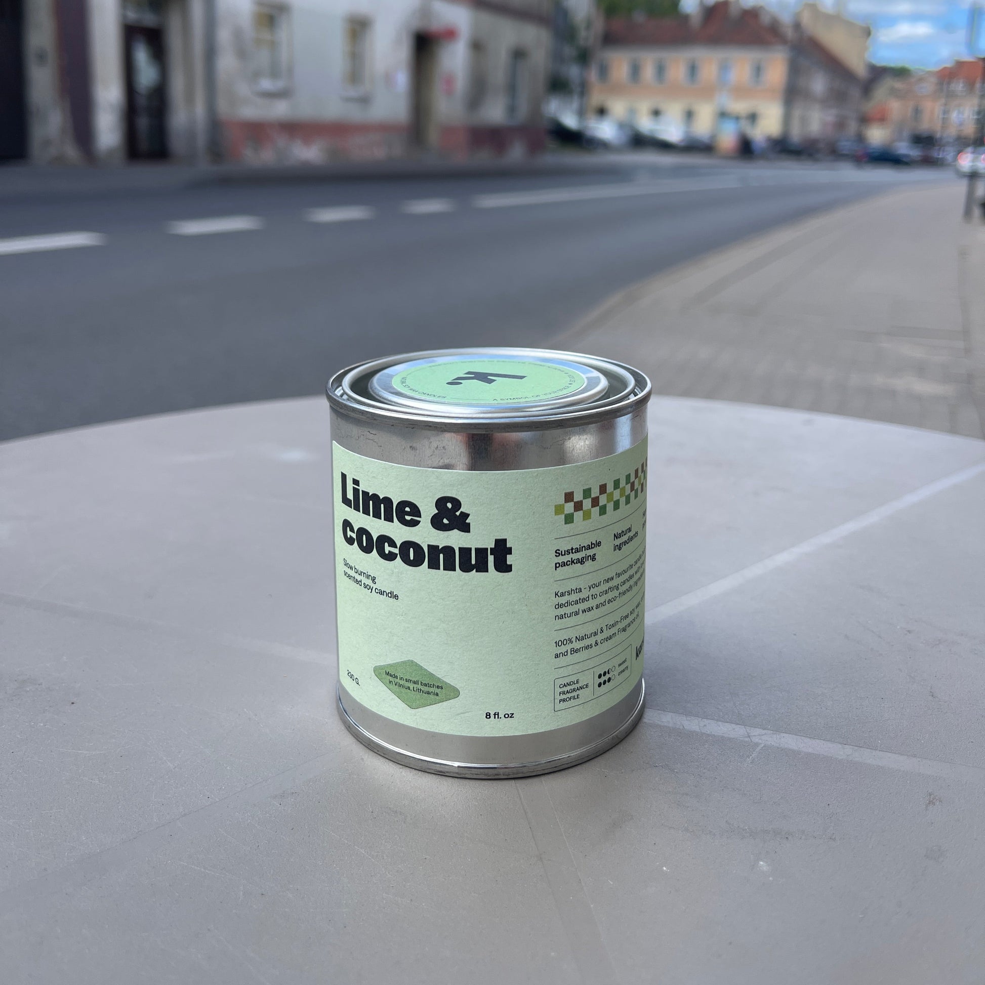 Can of 'Lime & Coconut' on a street with buildings in the background